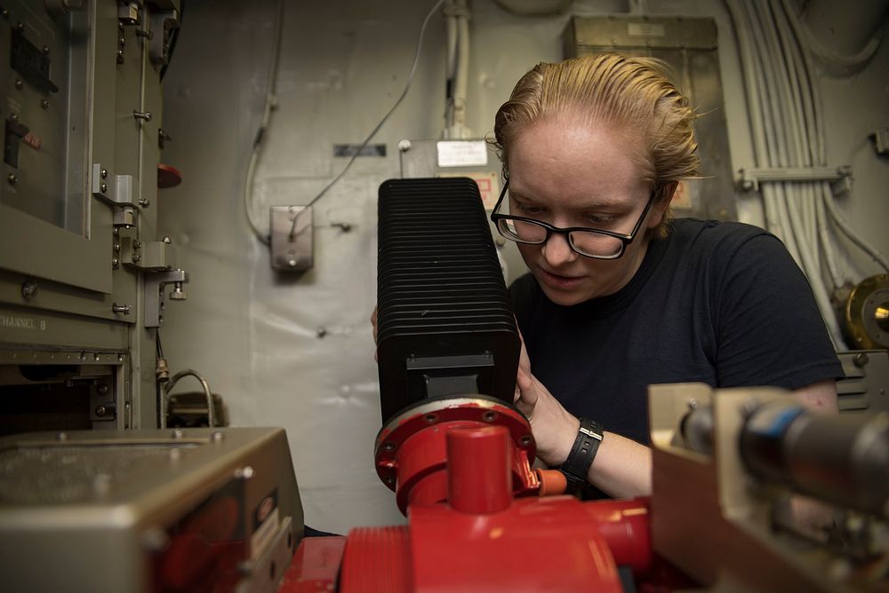 U.S. Navy Electronics Technician 3rd Class Danielle Calvert, from Corpus Christi, Texas, conducts maintenance on a water…
