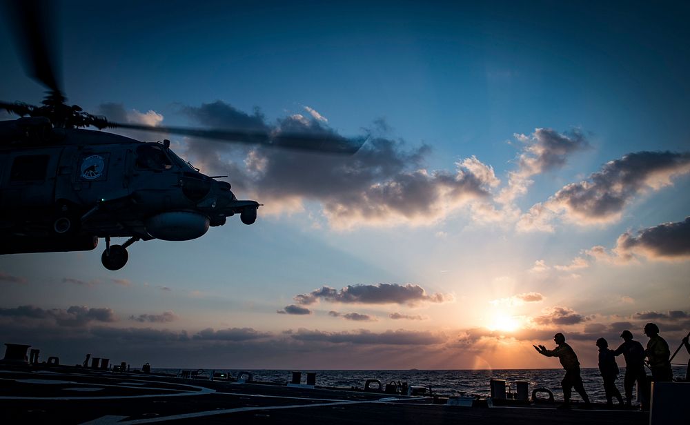 U.S. Navy Seaman Chance Vaughan guides an Egyptian Naval Force S-70B Sea Hawk helicopter onto the flight deck of the Arleigh…