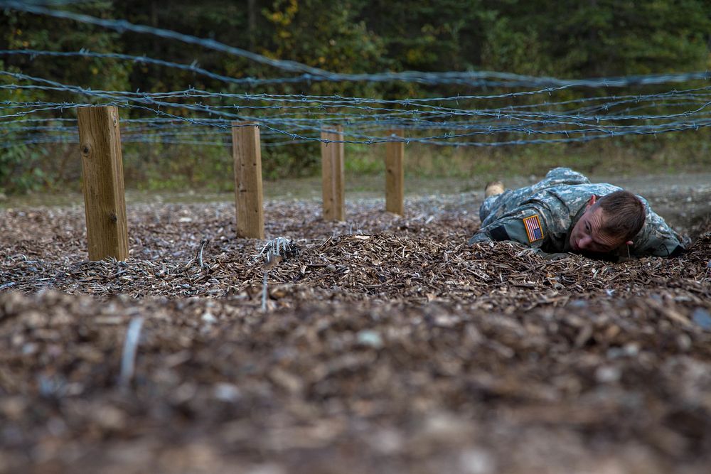 U.S. Army Spc. Zachary White, an infantry Soldier with 1-297th Infantry Battalion, competes in the obstacle course event…