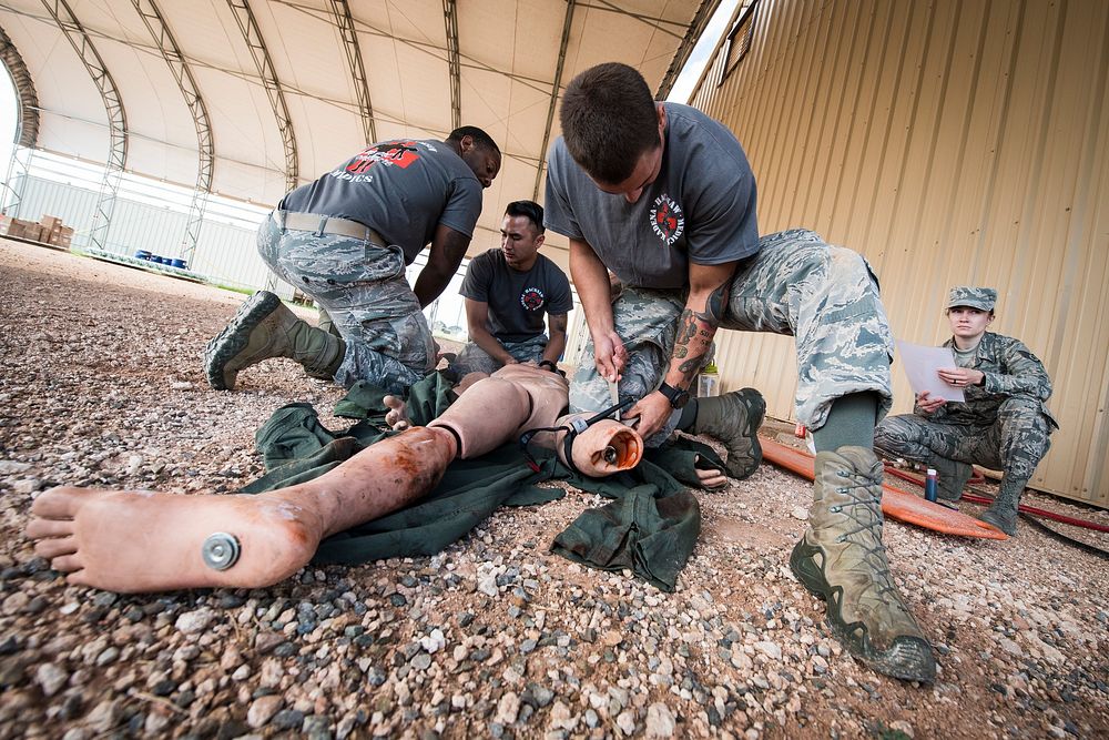 U.S. Air Force Emergency Medical Technician Rodeo participants treat a medical dummy during a simulated medical emergency…