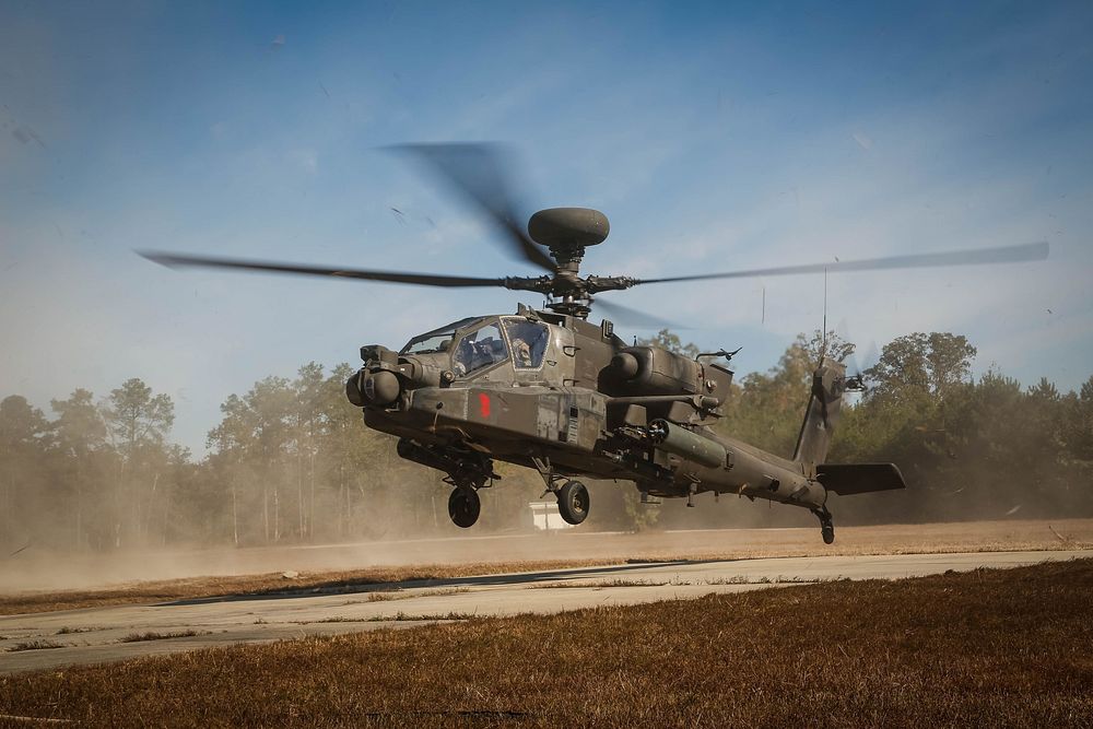 AH-64D apaches from 1st Attack Reconnaissance Battalion, 82nd Combat Aviation Brigade, descends onto the forward rearming…