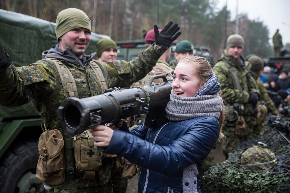A Lithuanian girl holds a rocket launcher at a static display in Visaginas, Lithuania, Nov. 26, 2016.