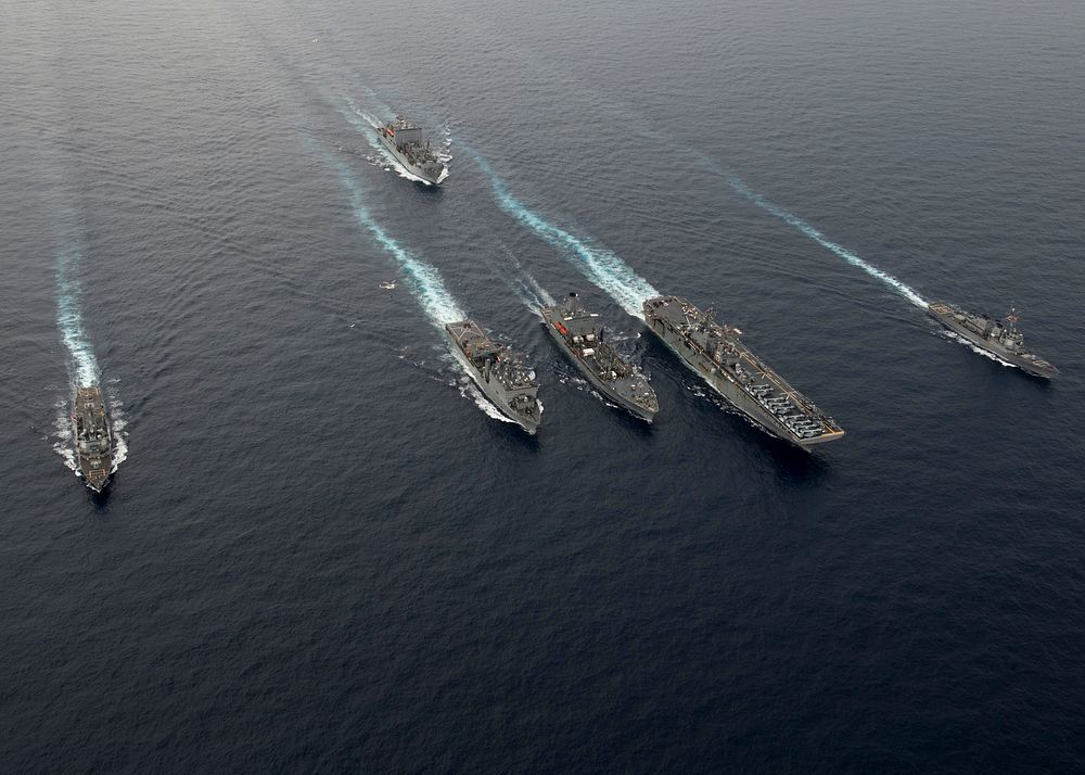 Clockwise from left, the guided-missile destroyer USS Spruance (DDG 111), the Military Sealift Command (MSC) ammunition and…