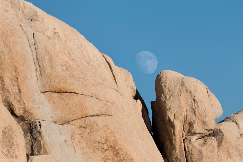 Moon rising over boulders
