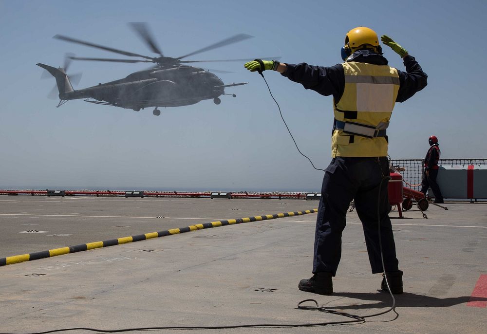 British army Warrant Officer 2 Will McKerrell directs a Sea Dragon MH-60 helicopter onto the Royal Fleet Auxiliary landing…