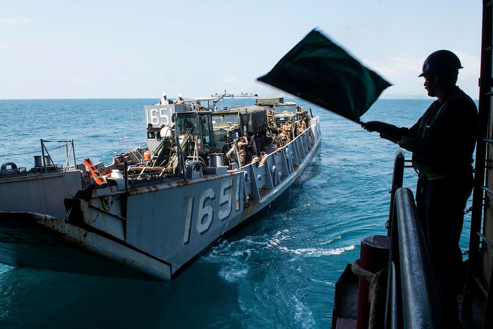 U.S. Navy Landing craft utility (LCU) 1651, assigned to Naval Beach Unit (NBU) 7, departs the well deck of the amphibious…