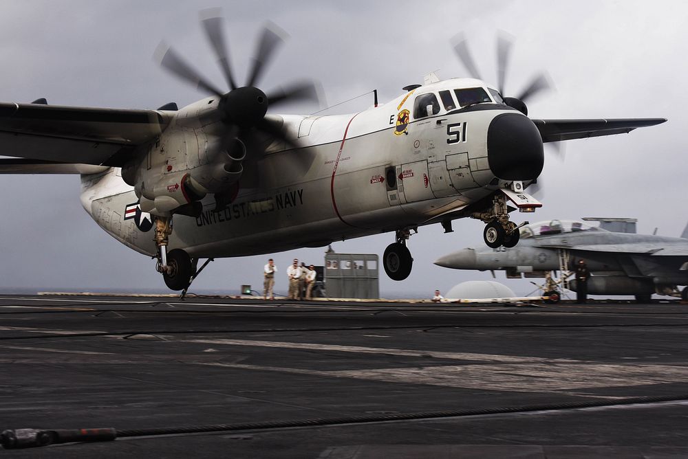 A U.S. Navy C-2A Greyhound, assigned to the 'Rawhides' of Fleet Logistic Support Squadron (VRC) 40, lands aboard the Nimitz…