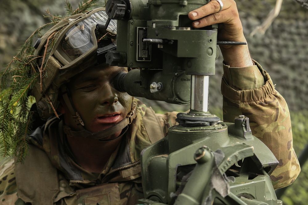 U.S. Army Sgt. Jason Vikre, assigned to the 2nd Cavalry Regiment, adjusts the aim of the M777 towed 155 mm howitzer while…