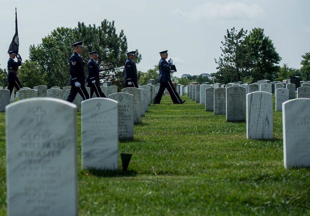 U.S. Air Force Ceremonial Guardsmen escort the remains of retired Col. Bruce Olmstead during his funeral at Arlington…
