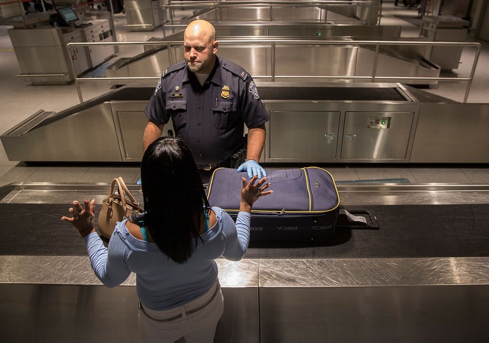 Officers with the U.S. Customs and Border Protection, Office of Field Operations, process international arrivals of…