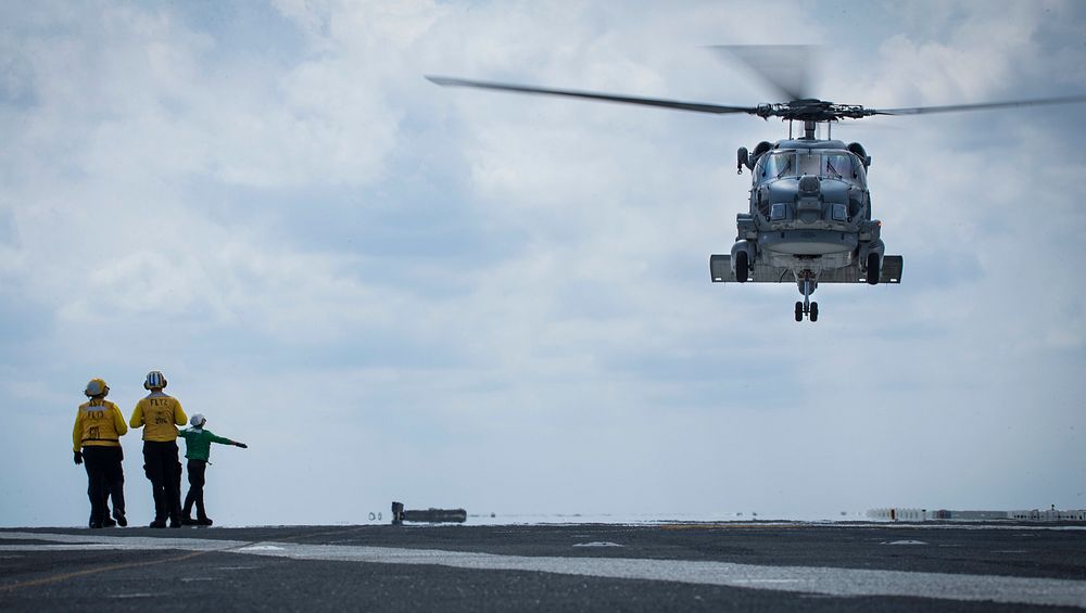 A U.S. Navy MH-60R Sea Hawk helicopter assigned to Helicopter Maritime Strike Squadron (HSM) 74 takes off from the flight…