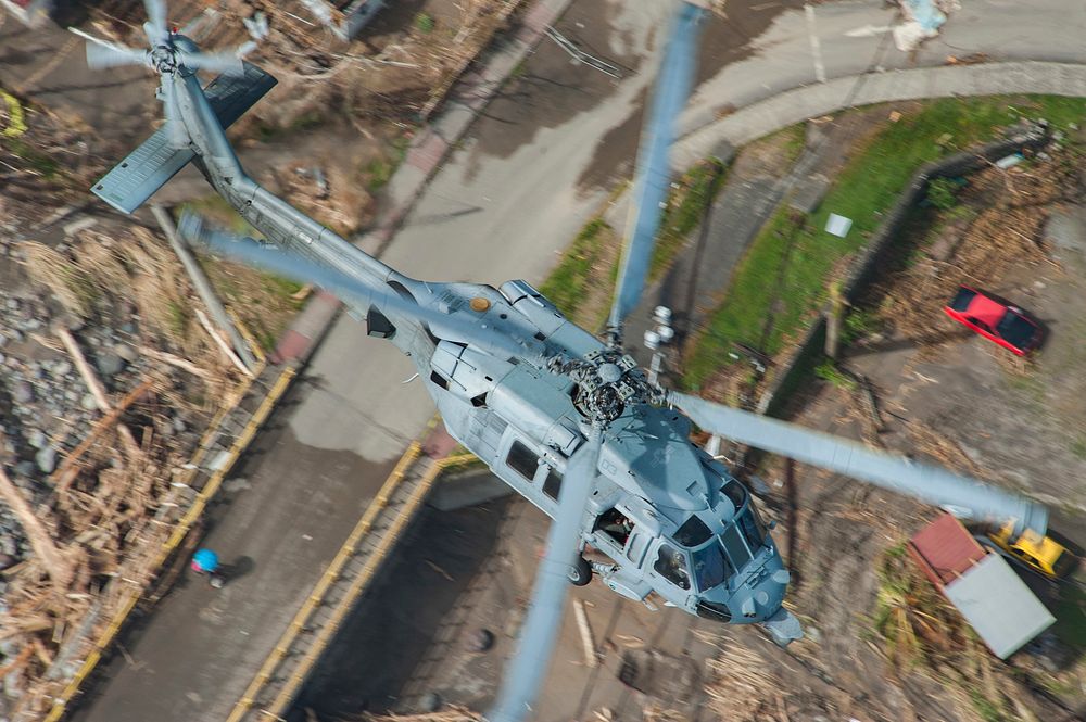 An MH-60S Sea Hawk helicopter flies over the island of Dominica during U.S. citizen evacuations and humanitarian relief…