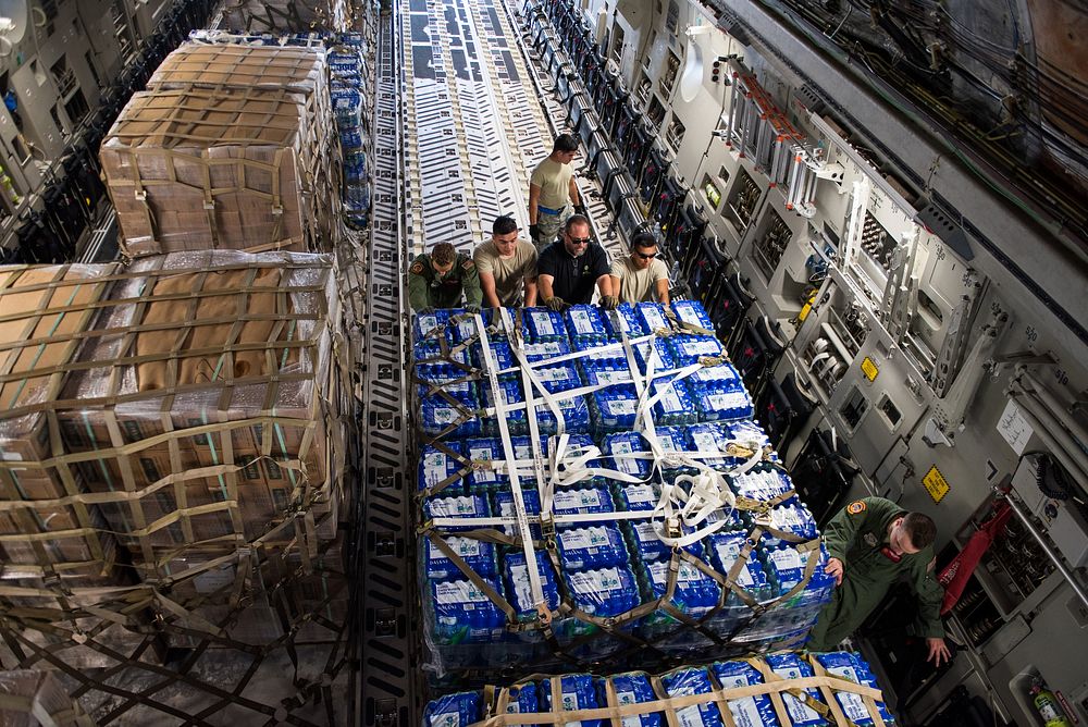 A U.S. Air Force C-17 Globemaster III aircraft assigned to Travis Air Force Base, Calif., is loaded with humanitarian aid…
