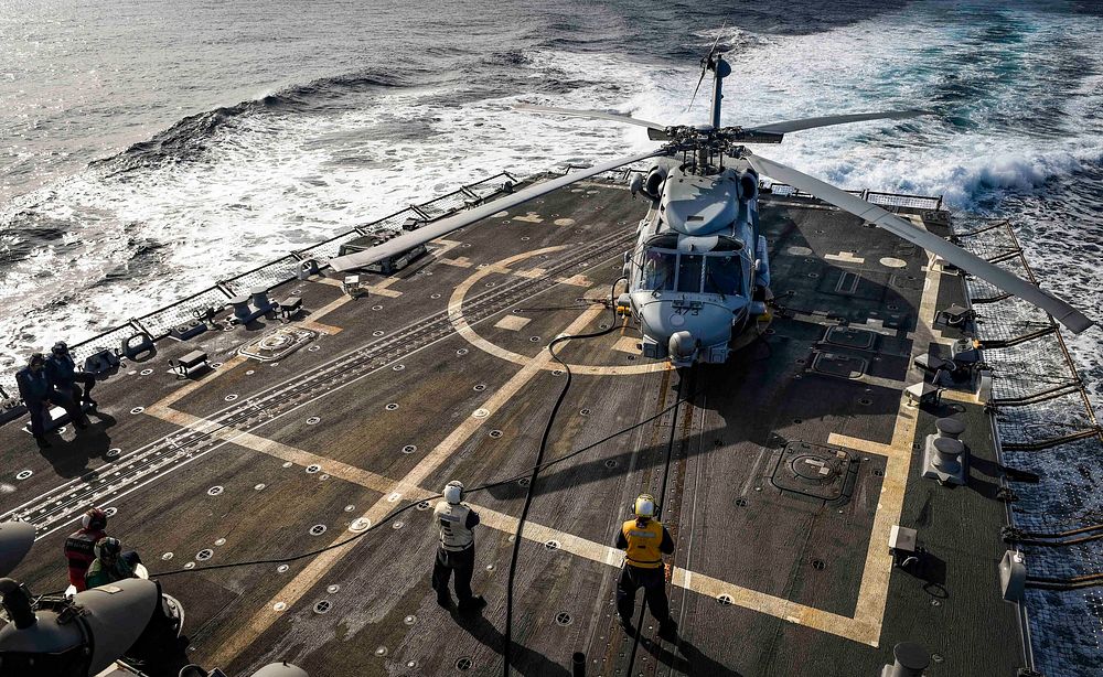 U.S. Sailors prepare an MH-60R Sea Hawk helicopter assigned to Helicopter Maritime Strike Squadron (HSM) 46 for flight…
