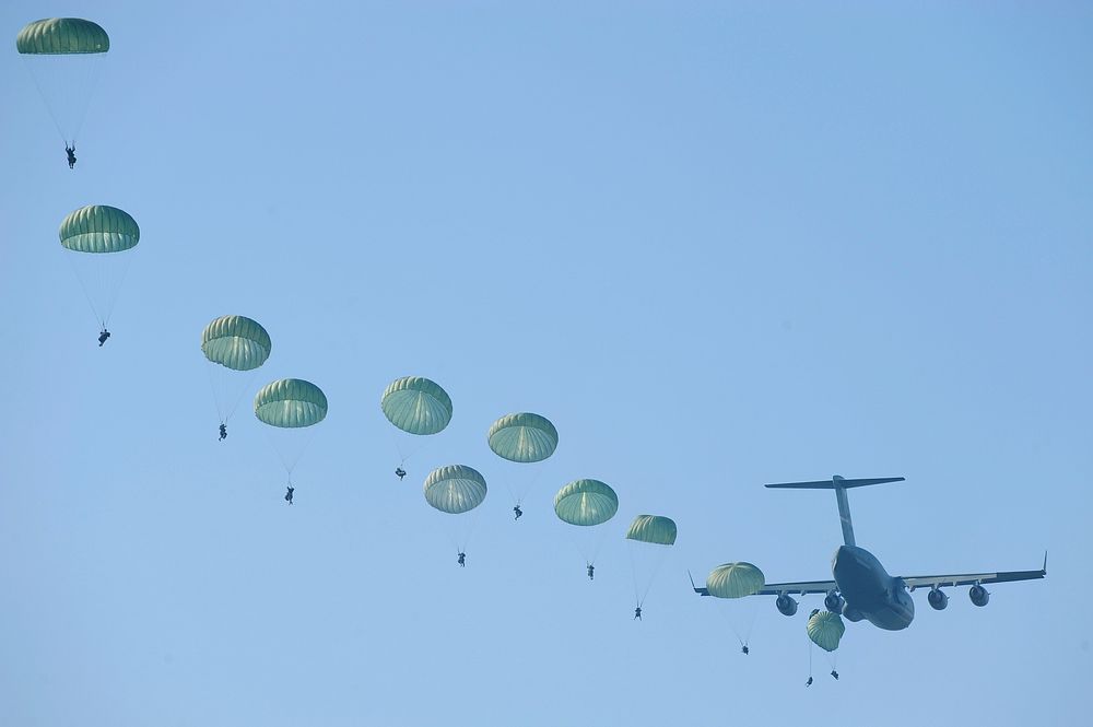 U.S. Army rangers parachute from an Air Force C-17 Globemaster III aircraft Aug. 3, 2009, during a mass tactical jump over…