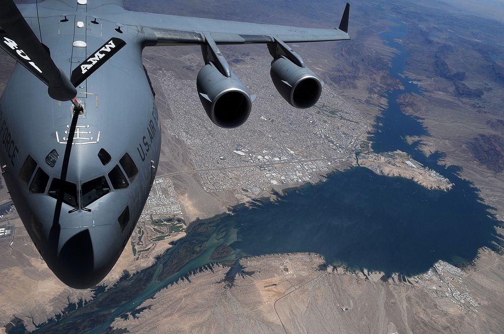A C-17A Globemaster III aircraft from the 729th Airlift Squadron refuels from a KC-135R Stratotanker aircraft with the 336th…