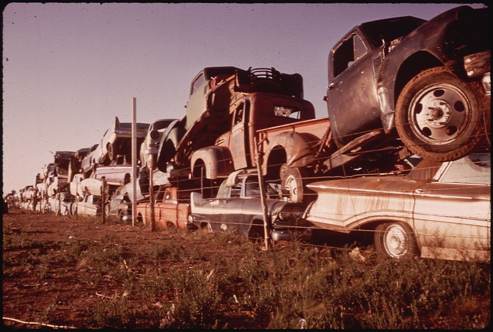 Junked Automobiles Are Piled Three Deep Along Fence. Photographer: Lyon, Danny. Original public domain image from Flickr