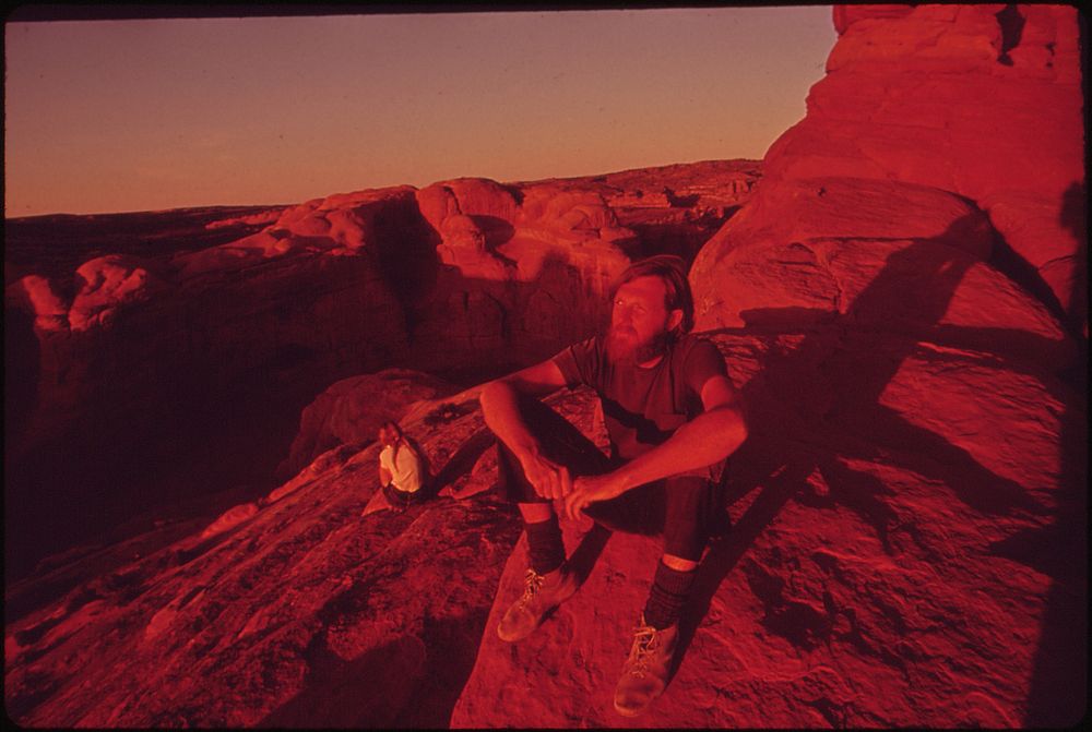 Backpackers Terry Mcgaw and Glen Denny Rest in the Setting Sun at the End of the Trail to Delicate Arch, 05/1972. Original…