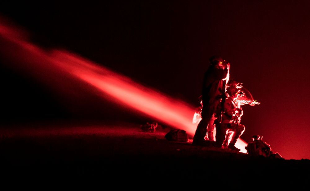 U.S. Air Force pararescuemen and combat rescue officers, assigned to the 83rd Expeditionary Rescue Squadron, use flares to…
