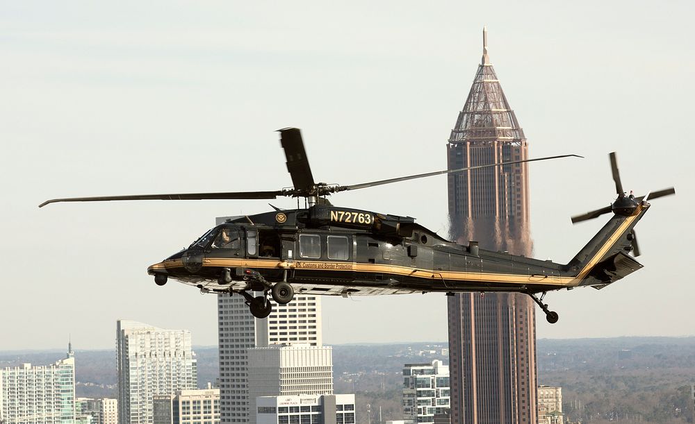 A U.S. Customs and Border Protection Air and Marine Operations UH-60 Black Hawk helicopter flies near Mercedes-Benz Stadium…