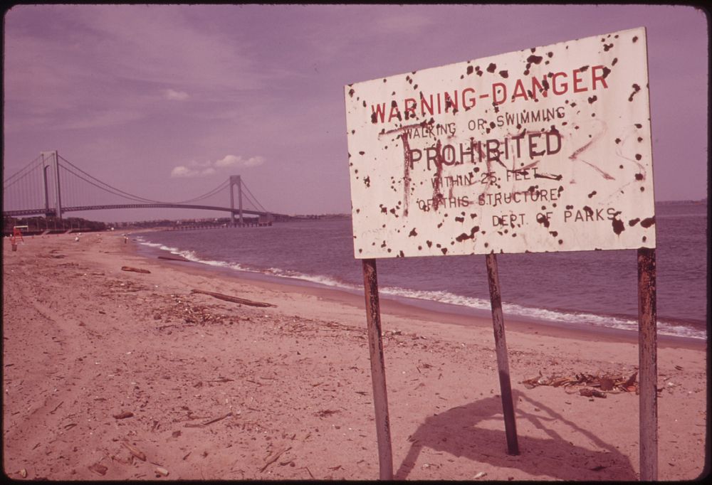 Warning of Polluted Water at Staten Island Beach Verrazano-Narrows Bridge in Background 06/1973. Photographer: Tress…