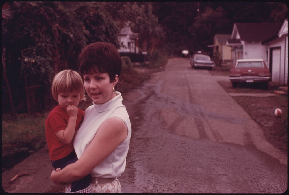 Mrs. Sharon Bowling, 25, and Son, Mark, 2, in the Street Outside Their Home in Cumberland, Kentucky 10/1974. Photographer:…
