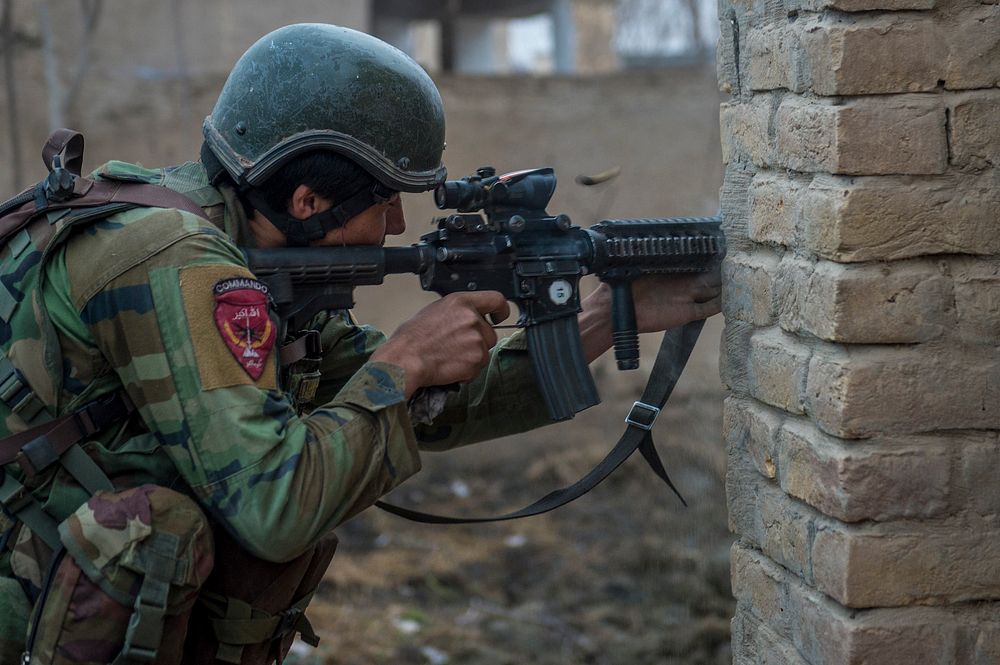 A 10th Special Operations Kandak Commando returns fire during offensive operations against the Taliban in Kunduz province…