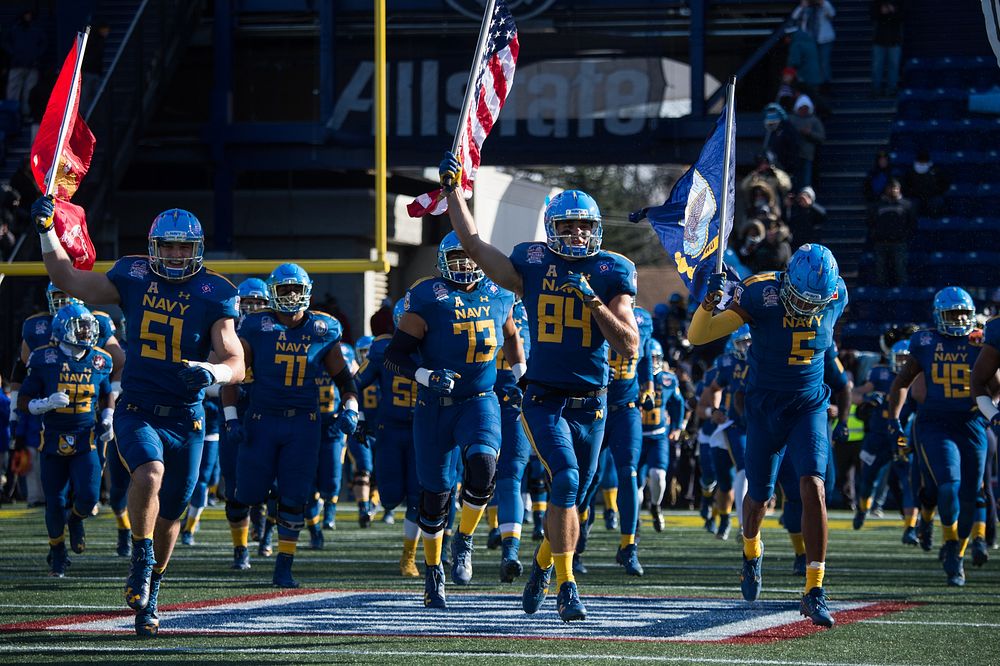 U.S Naval Academy football players take the field before the 2017 Military Bowl at the Navy – Marine Corps Memorial Stadium…