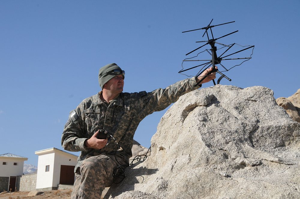 U.S. Army Cpl. Jason Ulin, with Provincial Reconstruction Team (PRT) Ghazni, sets up a tactical satellite to communicate…