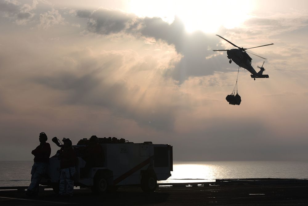 A U.S. Navy MH-60R Sea Hawk helicopter assigned to Helicopter Maritime Strike Squadron (HSM) 72 transports cargo during a…
