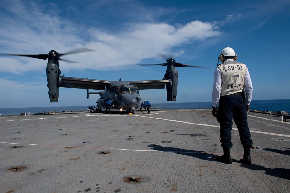 U.S. Sailors remove chocks and chains from a CV-22 Osprey aircraft assigned to the Air Force Special Operations Command…