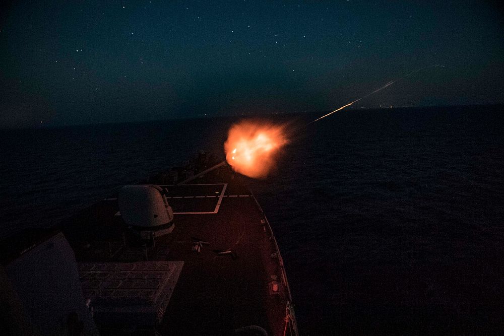 The Arleigh Burke-class guided-missile destroyer USS Porter (DDG 78) fires its 5-inch gun during a live-fire exercise in the…