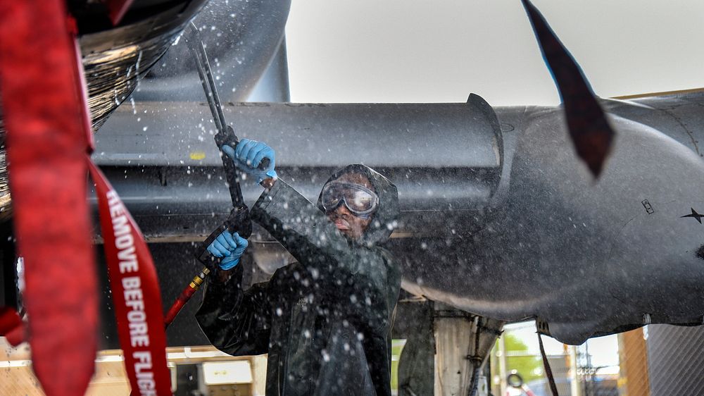 U.S. Air Force Airman 1st Class Keon Oliver, 355th Aircraft Maintenance Squadron weapons load crew member, hoses down an A…