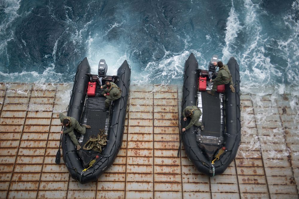 Australian sailors prepare to launch combat rubber raiding craft from the stern gate of the amphibious dock landing ship USS…