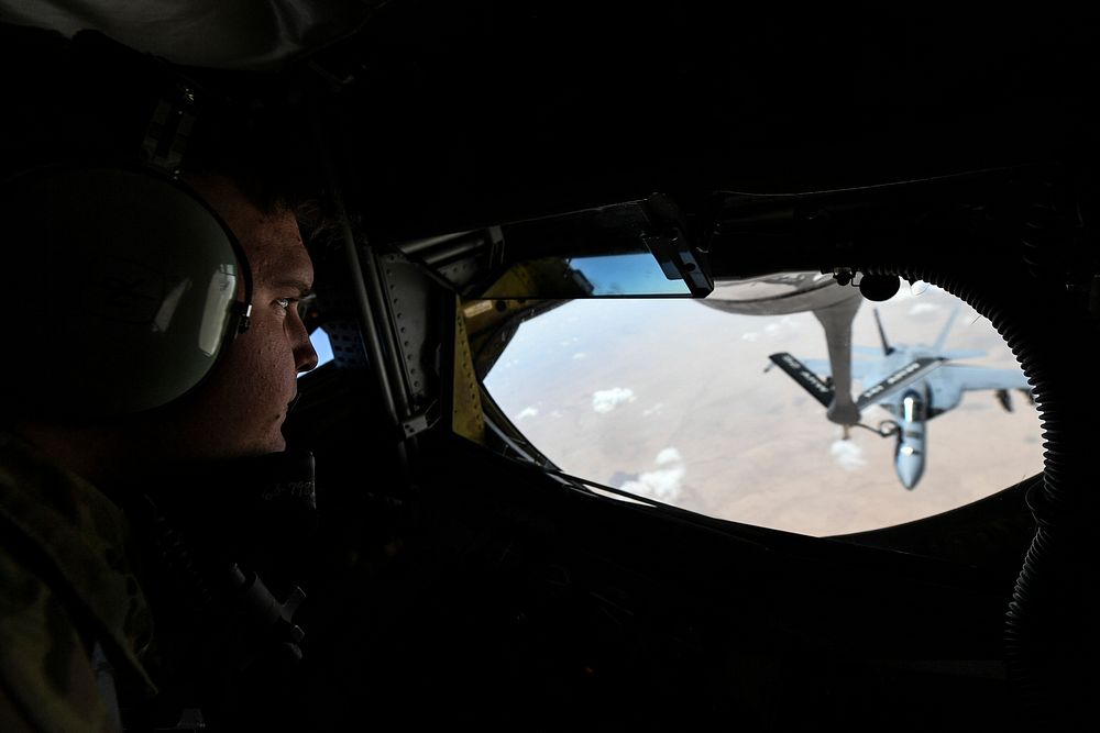 A U.S. Air Force KC-135 Stratotanker boom operator, assigned to the 340th Expeditionary Air Refueling Squadron, refuels a…