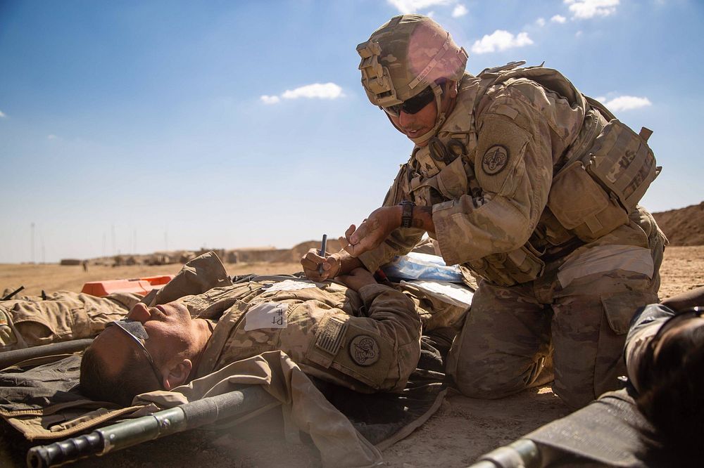 U.S. Army Sgt. Joshua Padilla, assigned to the 3rd Cavalry Regiment, writes vital information on a simulated casualty during…