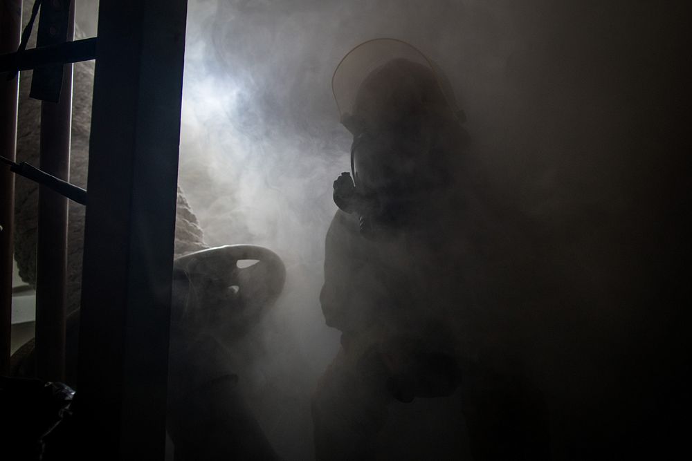 A U.S. Sailor leads a hose team during a general quarters drill aboard the guided-missile destroyer USS Dewey (DDG 105)…
