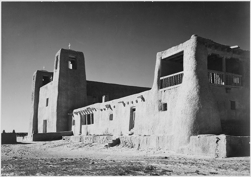 Corner view showing mostly left wall, "Church, Acoma Pueblo [National Historic Landmark, New Mexico]." Photographer: Adams…