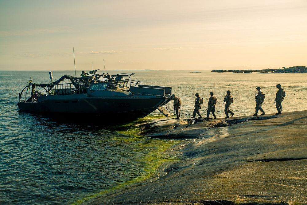 Swedish Marines and Marines with Marine Rotational Force-Europe board Swedish Combat Boat 90 (CB-90) during amphibious…