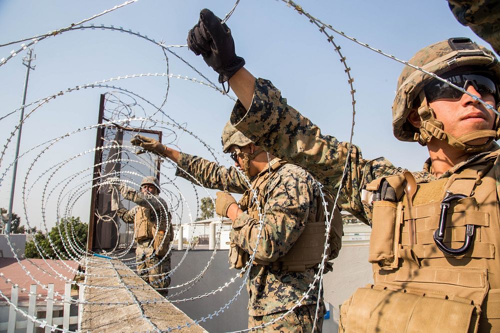 U.S. Marines with 7th Engineer Support Battalion, Special Purpose Marine Air-Ground Task Force 7, place concertina wire at…