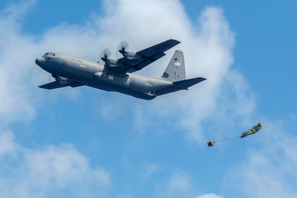 A Low-Cost, Low-Altitude bundle is airdropped out of a C-130J Super Hercules at Operation Christmas Drop 2018 at Andersen…