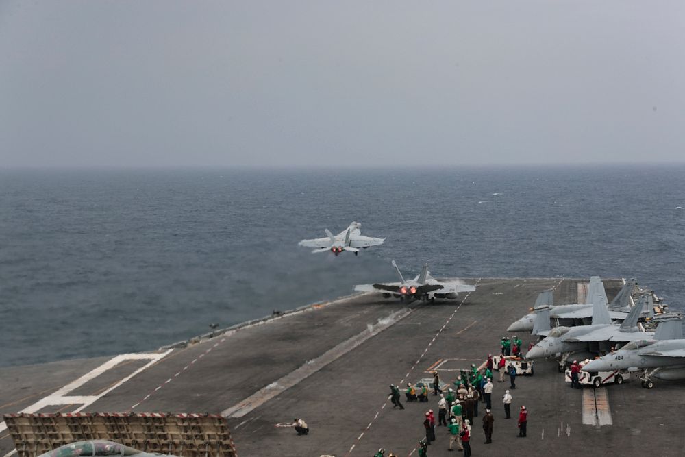 Two F/A-18E Super Hornets from the "Pukin' Dogs" of Strike Fighter Squadron (VFA) 143 launch from the flight deck of the…