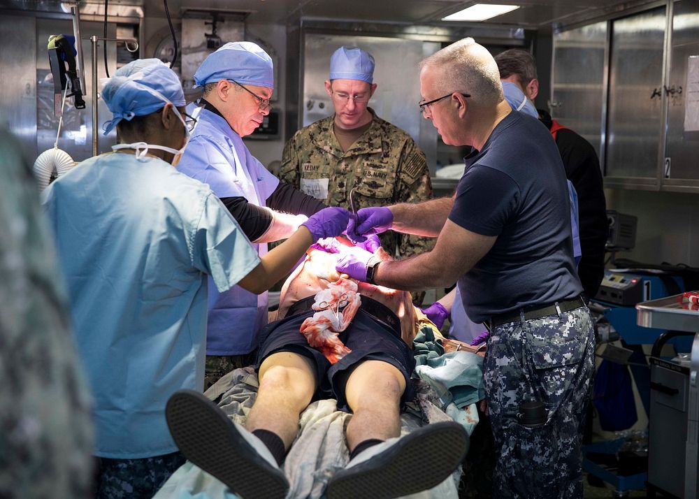 U.S. Sailors assigned to Fleet Surgical Team Six perform surgery on a simulated patient in the operating room aboard the the…