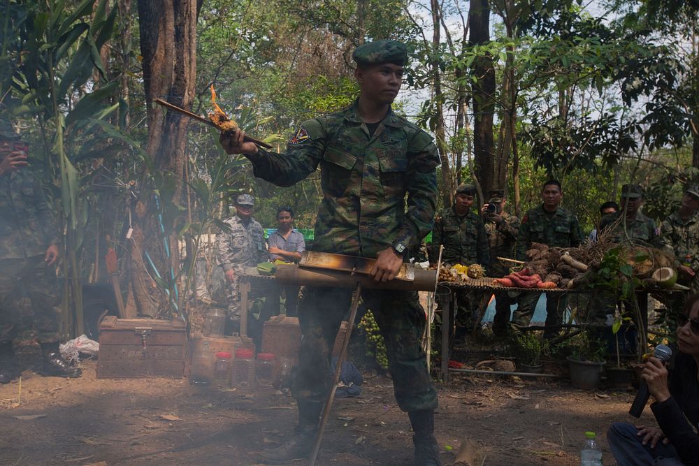 A Royal Thai Marine teaches Marines how to start a fire out of bamboo in a demonstration during a jungle training event of…
