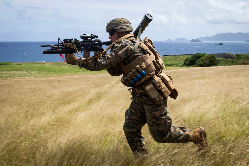 A U.S. Marine with Fox Company, 2nd Battalion, 3rd Marine Regiment, III Marine Expeditionary Force, charges toward a target…