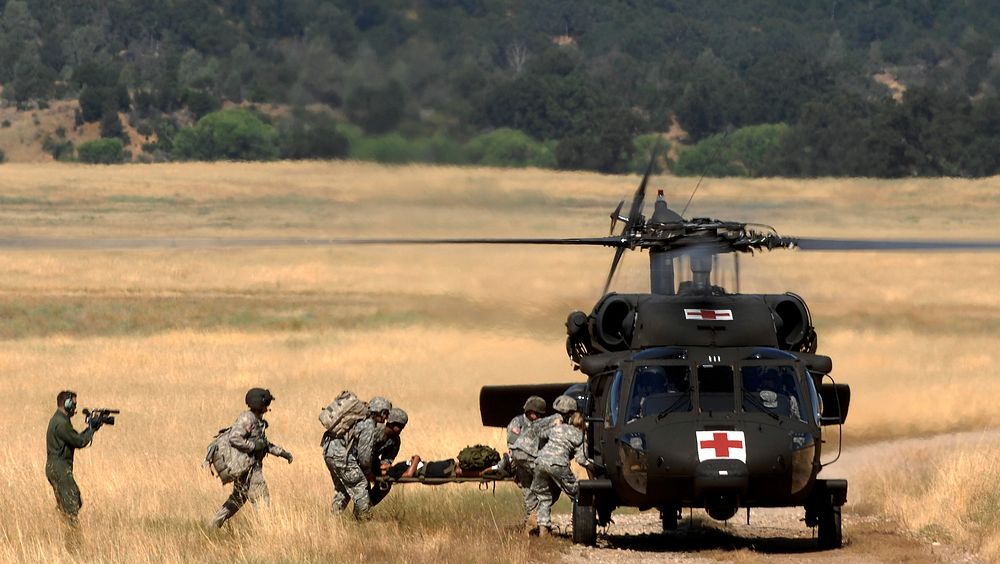 U.S. service members transfer a simulated casualty to a UH-60 Black Hawk helicopter at Fort Hunter Liggett, Calif., July 16…