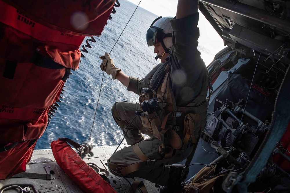 U.S. Navy Aircrewman (Helicopter) 2nd Class Dillan Hansen, from Casper, Wyoming, conducts a simulated search and rescue…