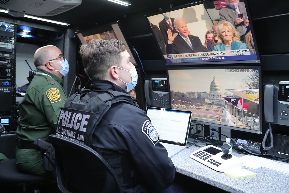 U.S. Customs and Border Protection officers and agents observe activities from a tactical command vehicle near the U.S.…