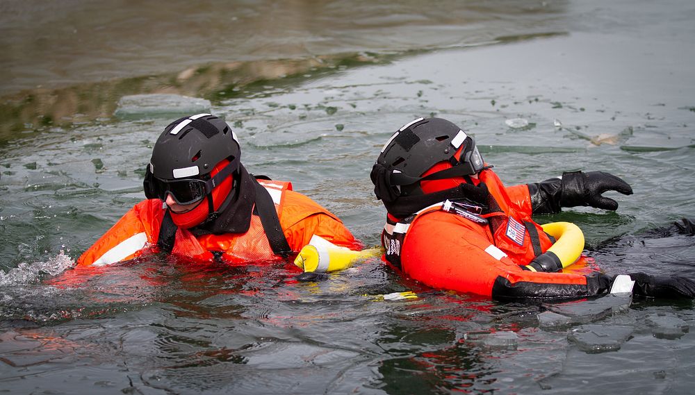 Members of the Coast Guard conduct ice rescue training with a simulated survivor in the water at U.S. Coast Guard Station…