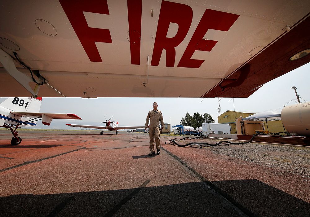 JUL 16 BLM Fire. LAKEVIEW, OR - JULY 16: Single Engine Air Tanker pilot Chuck Gardner walks to his aircraft at the Lakeview…